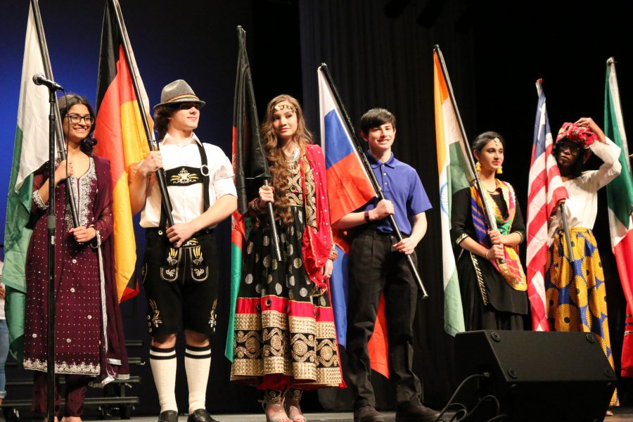 uniors Mitya Gull, Bryce Treichel, Dolhan Mohammadi, Helen Varghese and sophomore Luke Hubbard greet the crowd after the models perform on stage with their flags. “I was representing Germany for U-Nite. Germany has a rich history and has unique cultural traditions and clothing. My family was originally from there in the 1800’s. My favorite tradition of Germany is the lederhosen they wear,” said Treichel. 