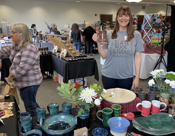 Erin Landavere proudly holds one of her pottery pieces at a Holiday In Leesburg craft fair.